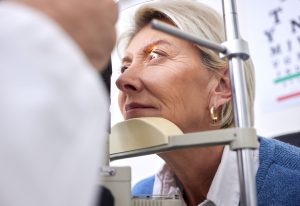 Ältere Frau bei augenärztlicher Untersuchung mit Spaltlampe – wichtige Vorbereitung zur Beurteilung, ob eine Augenlaserbehandlung ab 60 Jahren infrage kommt.